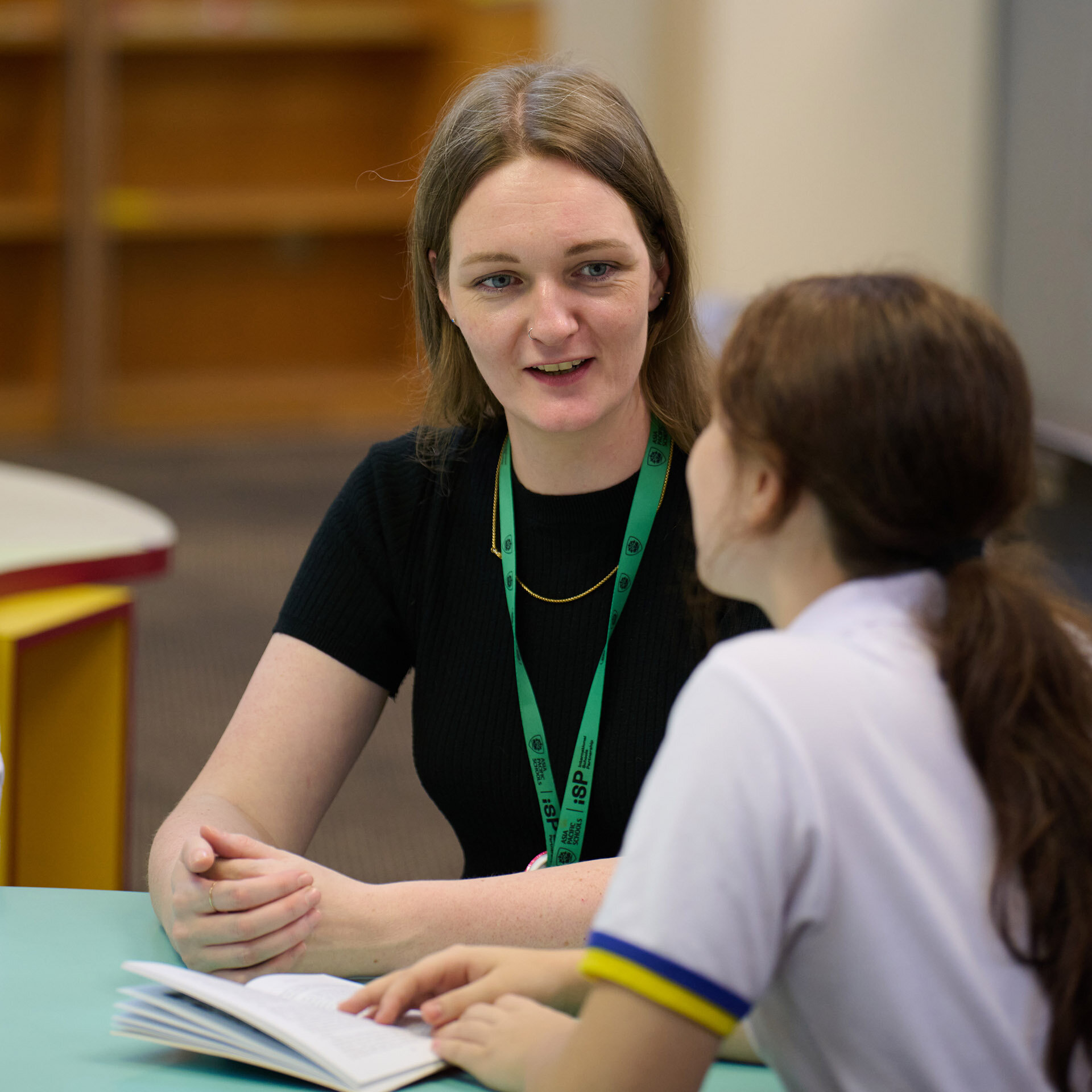 Teacher talking to one of her students