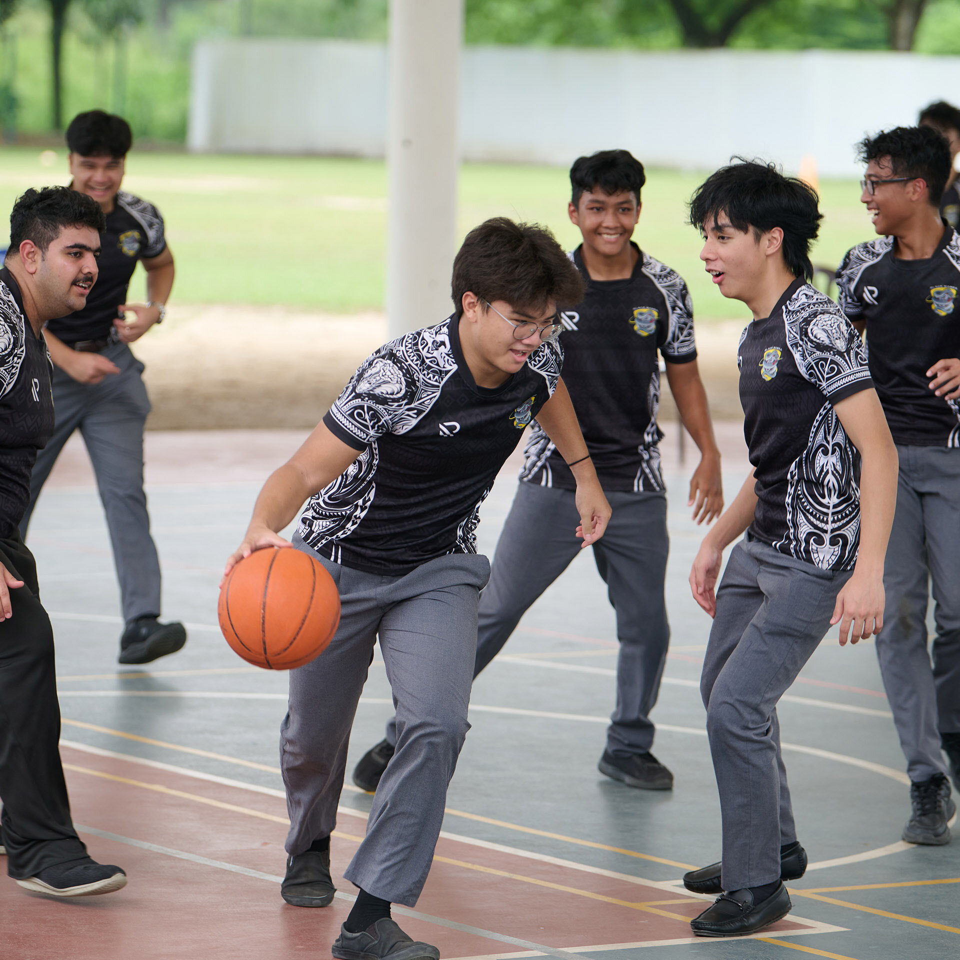 Teenagers playing basketball